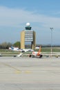 Vertical shot of planes passing in front of the control tower in Budapest airport, Hungary