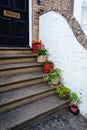 Vertical shot of plants on pots on the stairs of the old house on the street Royalty Free Stock Photo