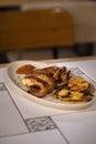 Vertical shot of a Polvo a Lagareiro served in a white oval plate