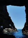 Vertical shot of the Poris de Candelaria cave openings into blue sea, Tijarafe, Canary Islands