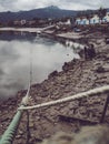 Vertical shot of a port with many boats on a gloomy day with mountains on a background Royalty Free Stock Photo