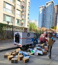 Vertical shot of the postal delivery officer carrying packages on the street in Beijing, China