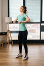 Vertical shot of pretty young woman taking deep breathing relaxing meditating with closed eyes enjoying peace at home on Royalty Free Stock Photo