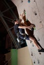 Professional climber training indoors on a rock wall