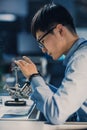 Vertical Shot of a Professional Japanese Electronics Development Engineer in Blue Shirt Royalty Free Stock Photo