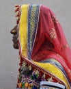 Vertical shot of profile of an Indian woman with her traditional colorful saree