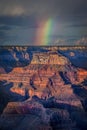 Vertical shot of a rainbow over a rock formation scenery Royalty Free Stock Photo