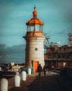 Vertical shot of the Ramsgate Lighthouse with a couple in the foreground, Ramsgate, United Kingdom Royalty Free Stock Photo