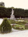 Vertical shot of The Rape of Persephone statue in the garden