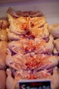 Vertical shot of raw fresh chicken meat slices on a display of a market counter Royalty Free Stock Photo