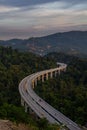 Vertical shot of Rawang Bypass highway amid green forest with dense trees in Malaysia
