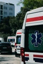 Vertical shot of the rear side of a white ambulance van, parked in Split, Croatia amid the coronavirus outbreak. Multiple vans