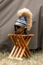 Vertical shot of a recreated Roman helmet on a stool