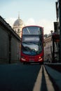 Vertical shot of a red autobus driving in the street