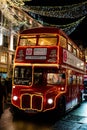 Vertical shot of a red bus in Regent Street, London at night Royalty Free Stock Photo