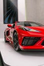 Vertical shot of a red Chevrolet Corvette Stingray Z51 in a showroom on a white wall background Royalty Free Stock Photo