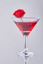 Vertical shot red cocktail with rose flower. Royalty Free Stock Photo