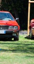 Vertical shot of a red Maserati Biturbo car parked on the grass