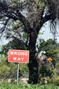 Vertical shot of a red sign wrong way in the forest Royalty Free Stock Photo