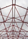 Vertical shot Red steel structure skeleton with cloudy sky in the background. Royalty Free Stock Photo