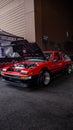 Vertical shot of a red Toyota AE86 with an opened hood Royalty Free Stock Photo