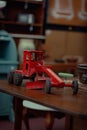 Vertical shot of a red tractor miniature in a thrift store