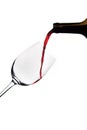 Vertical shot of red wine pouring from a bottle into a glass isolated on a white background Royalty Free Stock Photo