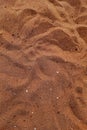 Vertical shot of reddish sand grains