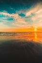 Vertical shot of the reflection of the sunset in the beautiful sky over the sea captured in Bali Royalty Free Stock Photo