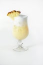 Vertical shot of a refreshing pineapple cocktail in a glass on a white background Royalty Free Stock Photo