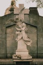 Vertical shot of a religious sculpture in the Chacarita Cemetery in Buenos Aires, Argentina.