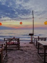 Vertical shot of a restaurant on the beach in Thailand with colorful lanterns at sunset Royalty Free Stock Photo