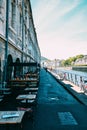 Vertical shot of the restaurants on the sidewalk by a canal Royalty Free Stock Photo