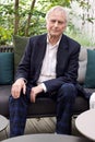 Vertical shot of Richard Dawkins at a conference on Dissent in Koln looking at camera and smiling