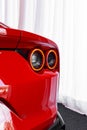 Vertical shot of the right taillight of a red Ferrari 812 Superfast