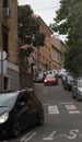Vertical shot of the Rijeka street, Croatia, Europe with trees, cars and buildings.