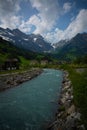 Vertical shot of a river in the countryside surrounded by a wild landscape Royalty Free Stock Photo