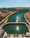 Vertical shot of a river next to roads in the city under a clear blue sky Royalty Free Stock Photo