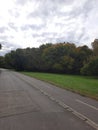 Vertical shot of a road against trees and green lawn in Ada Ciganlia, Belgrade, Serbia Royalty Free Stock Photo