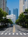 Vertical shot of a road with the background of tall buildings