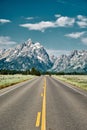 Vertical shot of a road leading to Grand Teton National Park, Wyoming USA Royalty Free Stock Photo