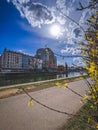 Vertical shot of a road by the river with the view of the Lighthouse Wien in Vienna, Austria.