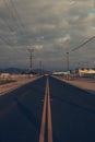 Vertical shot of a road under the sunlight and a cloudy sky in the evening - cool for backgrounds