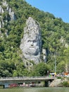 Vertical shot of Rock Sculpture of Decebalus and lush green vegetation in Romania Royalty Free Stock Photo