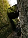 Vertical shot of rock stuck between two cliffs in Larvik, Norway