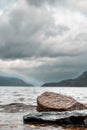 Vertical shot of the rocky shore of Loch Lomond Lake in Scotland