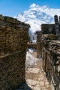 Vertical shot of the rocky stone walls in Annapurna circuit trek, Ghyaru in Nepal under blue sky Royalty Free Stock Photo