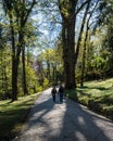 Vertical shot of a romantic couple walking at Villa Pallavicino park, Stresa, Piedmont, Italy Royalty Free Stock Photo