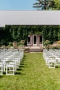 Vertical shot of the rows of chairs on the lawn outside for a wedding ceremony