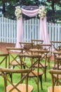 Vertical shot of rows of wooden tables on the outdoor wedding ceremony